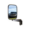 Direct Replacement Door Wing Mirrors with Arms (Pair) - MTC5217 for Defender 90/110/130, side view of vehicle mirror reflecting a black Land Rover Defender 90/110/130 in a grassy outdoor setting.
