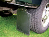 Product: Replacement Rear Mudflap Set for Discovery 1 (1989-1998), image showing a black mudflap attached to the rear wheel of a vehicle with a green body.