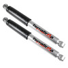 Terrafirma Pair of Terrafirma All-Terrain Rear Shock Absorbers for Discovery 2, durable silver shock absorbers with black protective covers and branding, designed for off-road vehicle suspension.