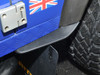 Britpart Rear of Front Wheel Dirt D-Fender Pair for Defender, close-up of black dirt fenders on a blue Land Rover Defender with rugged tires.