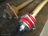 Terrafirma Defender/Discovery 1 Cranked Rear Radius Suspension Arm, a pair of metallic, pinkish-golden suspension arms used for the rear suspension of Land Rover Defender or Discovery 1 models.