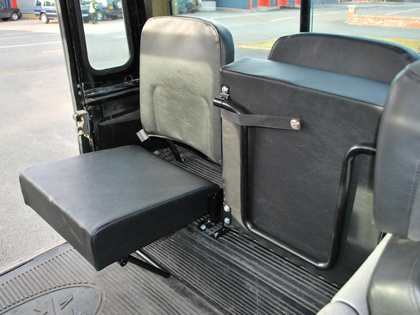 Britpart Pair of Rear Inward Facing Single Seats Black Vinyl for Defender (1986-2016) | DA4067, image of black vinyl rear inward facing single seats installed in a vehicle interior.