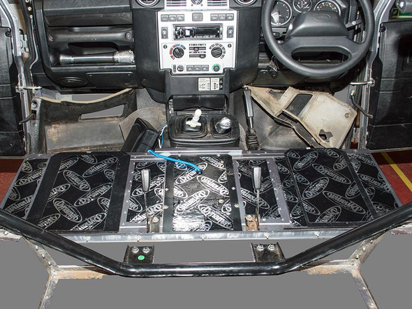 DYNAMAT Dynamat Seat Box Soundproofing Kit - DA8084 for Defender Puma, installed on vehicle's interior floor for sound insulation.