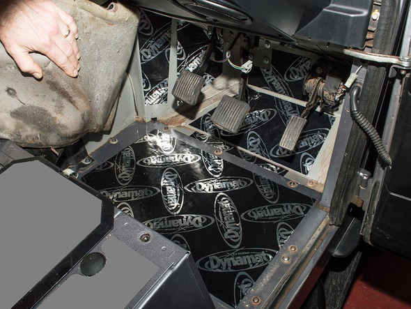 DYNAMAT Dynamat Front Footwell Soundproofing Kit - DA8083, installed in the footwell area of a Defender Puma, showing the black soundproofing material applied to the floor for noise reduction and insulation.