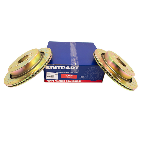 Britpart Rear Brake Discs Drilled and Grooved Performance Upgrade for Discovery 3, drilled and grooved brake discs with packaging in the background.