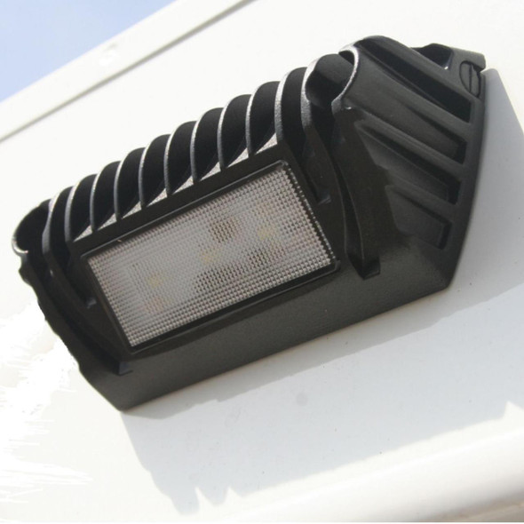 Wilderness Lighting Terrafirma TF719 Wilderness Scene LED Downlighter | TF719, close-up of a black outdoor LED downlight with a protective grille and heat sink, mounted on a white surface.