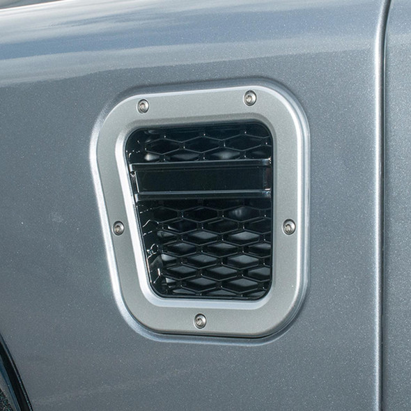 Britpart Left Hand Side XS Air Intake Grille for Defender, metallic silver automotive air vent with honeycomb pattern and mounting screws. Britpart Left Hand Side XS Air Intake Grille for Defender, metallic silver automotive air vent with honeycomb pattern and mounting screws.