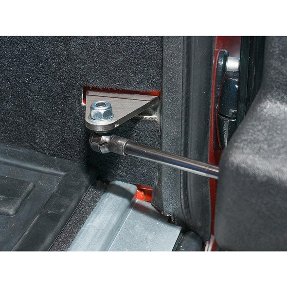 Britpart Rear Door Stay Kit 2002 Onwards for Defender, vehicle door hinge repair kit installed on rear door with mounting bolt and support arm.