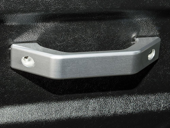 Britpart Silver Aluminium Interior Door Handle for Defender, close-up of the silver metallic door handle attached to black textured surface.