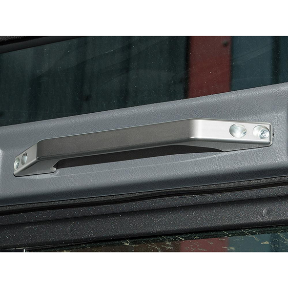 Britpart Silver Aluminium Interior Grab Handle for Defender, close-up of the shiny, metallic grab handle securely mounted on the vehicle's interior door panel.