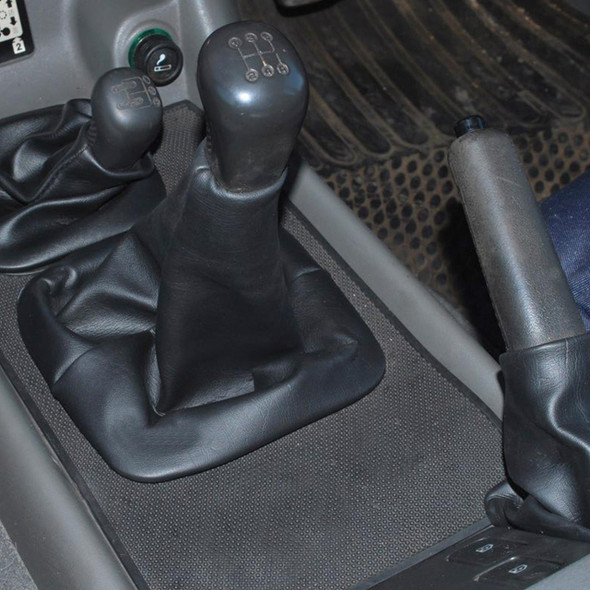 Britpart Handbrake Lever Gaiter for Discovery 1/2, close-up image of the black leather gear stick gaiter on a vehicle's handbrake lever.