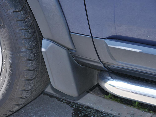 Terrafirma Front Mud Flaps for Discovery 3/4, close-up view of the front mud flaps installed on a blue Discovery 3 or 4, showing the mud flaps fitted behind the front tires.