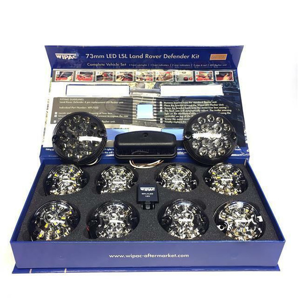 WIPAC Smoked LED Light Kit for Defender, complete vehicle set of LED lights with 12 smoked lens modules, black control box, and installation accessories in a blue box.