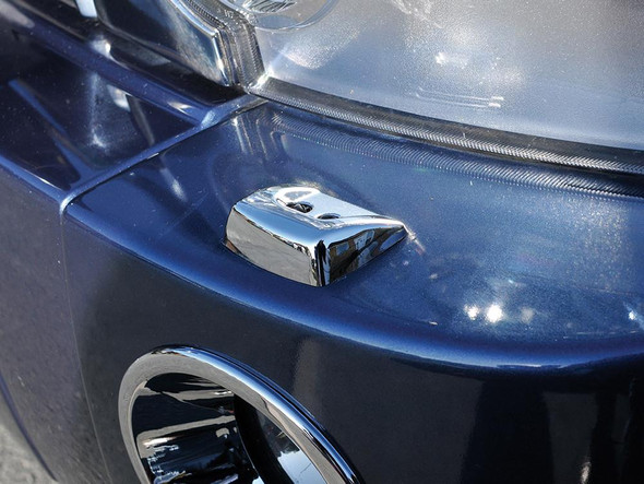 Britpart Range Rover Sport L320 Chrome Headlight Washer Jet Cap Pair, close-up of the shiny chrome headlight washer jet cap on a blue vehicle.