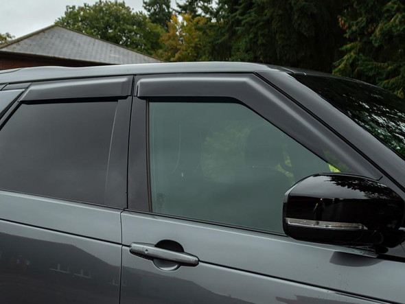Britpart Window Wind Deflector Set for Discovery 5, close-up view of the deflectors installed on the vehicle's front windows. Britpart Window Wind Deflector Set for Discovery 5, close-up view of the deflectors installed on the vehicle's front windows.