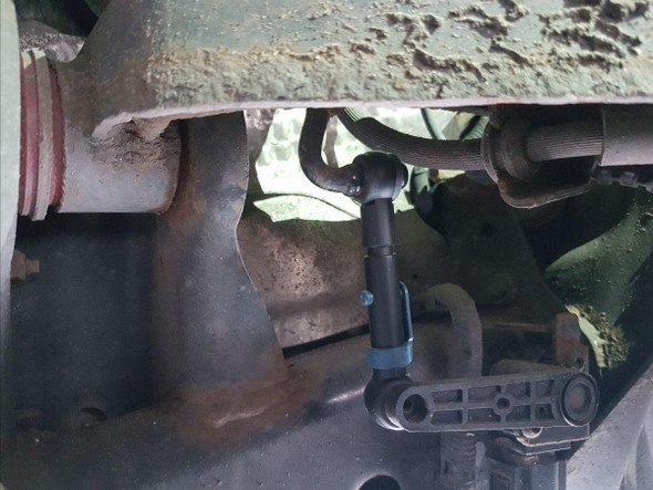 Terrafirma Suspension Lift Rods TERRAFIRMA for Range Rover Sport, close-up view of the lift rod installed underneath the vehicle's chassis.