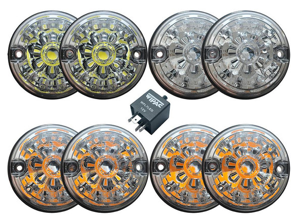 WIPAC Clear LED Lens Lamp Upgrade Kit 73mm Lens for Defender, set of four round LED lamps with clear lenses and a small relay in the center.