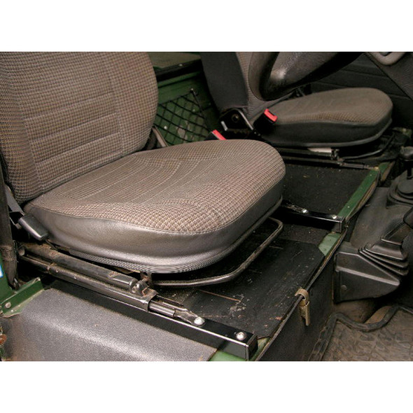 Britpart Seat Riser Raiser Rails for Enhanced Legroom for Defender, vehicle interior with elevated seat position, black metal rails installed under brown fabric seats.