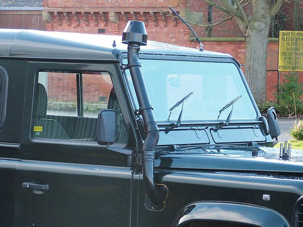 Britpart Raised Air Intake Kit for Defender 1994-2016, Right Hand Side, installed on vehicle with snorkel pipe and black exterior, on a Land Rover Defender model.