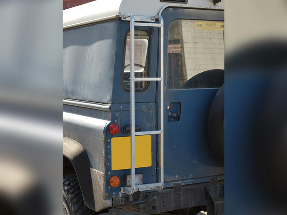 Britpart Series 1, 2 & 3 Galvanised Rear Roof Rack Access Ladder, image of a galvanised metal ladder attached to the rear of a blue Land Rover vehicle for roof access.