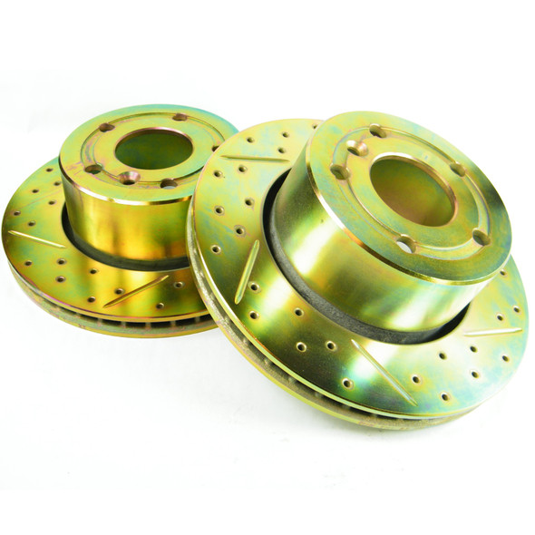 Britpart Front Vented Brake Discs Drilled and Grooved Performance Upgrade for Discovery 2, image of drilled and grooved brake discs with packaging in background. Britpart Front Vented Brake Discs Drilled and Grooved Performance Upgrade for Discovery 2, image of drilled and grooved brake discs with packaging in background.