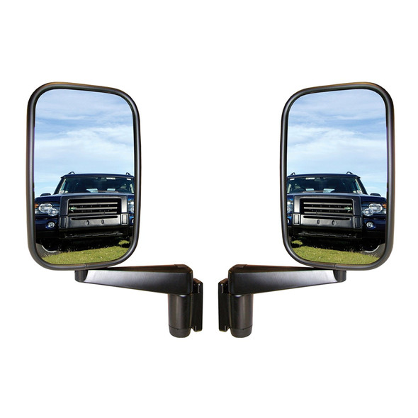 Direct Replacement Door Wing Mirrors with Arms (Pair) - MTC5217 for Defender 90/110/130, side view of two black wing mirrors showing reflective surfaces reflecting a Land Rover Defender vehicle on grassy terrain under a blue sky.