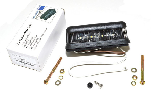WIPAC High-Quality LED Replacement Number Plate Light for Defender & Series, unboxed with installation screws and mounting hardware.