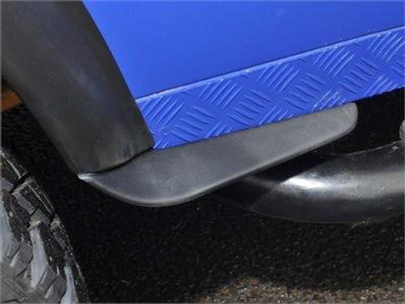 Britpart Dirt D-Fenders - Front Of Rear Wheel Pair For Defender 90 110, close-up view of black dirt deflectors installed on the sides of a vehicle's rear wheels to keep the sides cleaner.