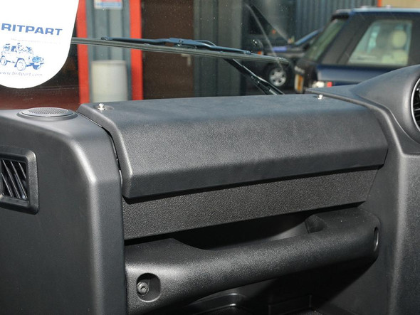 Britpart Glove Box Kit Black for Defender Puma, close-up of black glove box inside a vehicle's dashboard.