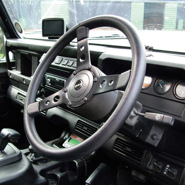 Britpart Defender & Series 2/2A/3 15" 3-Spoke Sports Steering Wheel, interior view of vehicle dashboard with steering wheel and gauges.
