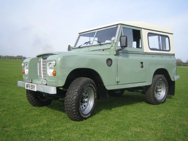 Classic Series 3 Land Rover parked in a field