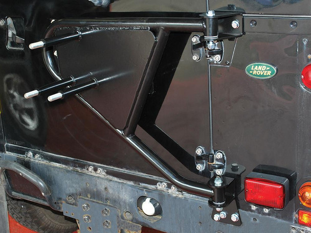 Britpart Swing Away Spare Wheel Carrier for Defender - DA2232, black metal spare wheel mount attached to the rear of a Land Rover Defender for easy access and convenience. Britpart Swing Away Spare Wheel Carrier for Defender - DA2232, black metal spare wheel mount attached to the rear of a Land Rover Defender for easy access and convenience.