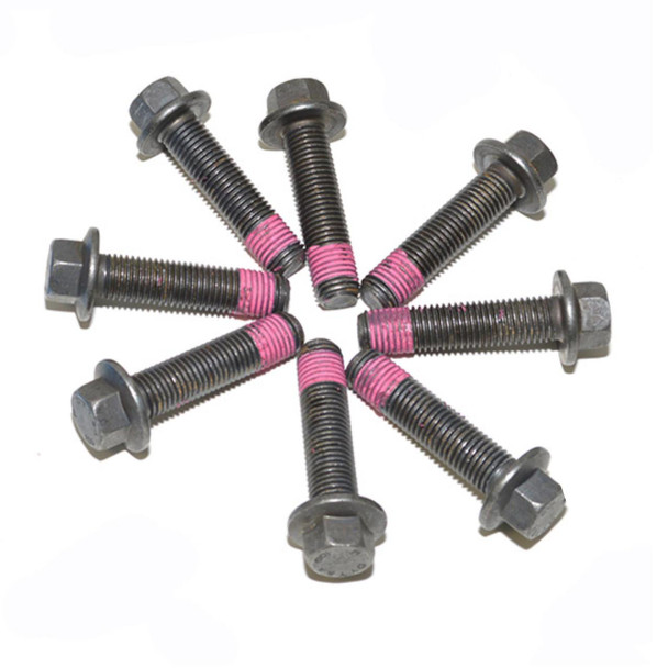 OEM Parts Dual Mass Flywheel Bolts for Discovery 2 & Defender Td5, group of automotive bolts with pink thread lock on some of them. OEM Parts Dual Mass Flywheel Bolts for Discovery 2 & Defender Td5, group of automotive bolts with pink thread lock on some of them.