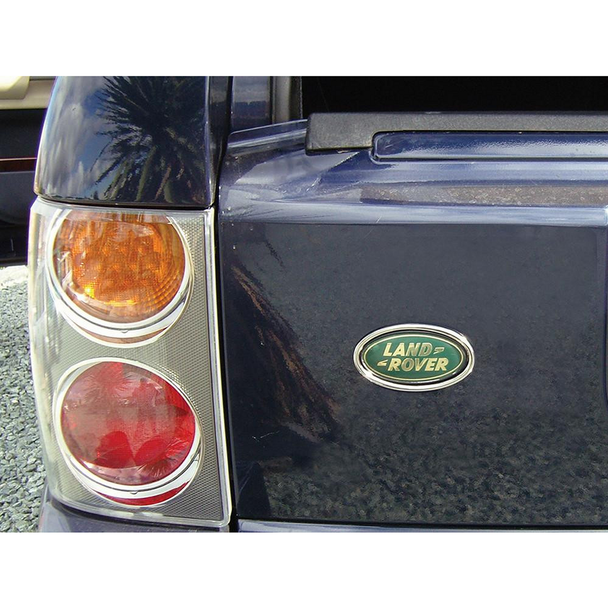 Britpart Chrome Rear Oval Badge Surround for Range Rover L322, close-up view showing the chrome oval badge surround on the rear of a black Range Rover L322 with tail lights