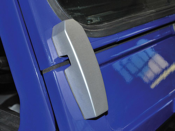 Britpart Billet Aluminium Windscreen Brackets DA1142 for Defender, Silver, close-up of the silver billet aluminium bracket mounted on a blue vehicle's windscreen. Britpart Billet Aluminium Windscreen Brackets DA1142 for Defender, Silver, close-up of the silver billet aluminium bracket mounted on a blue vehicle's windscreen.