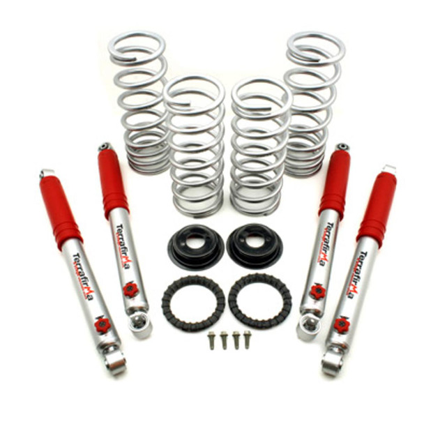 Terrafirma 2" Suspension Lift Medium Load Springs with 4-Stage Adjustable Shock Absorbers for Discovery 2, showcasing a set of coil springs, shock absorbers with red covers, mounting rings, and screws for vehicle suspension enhancement.