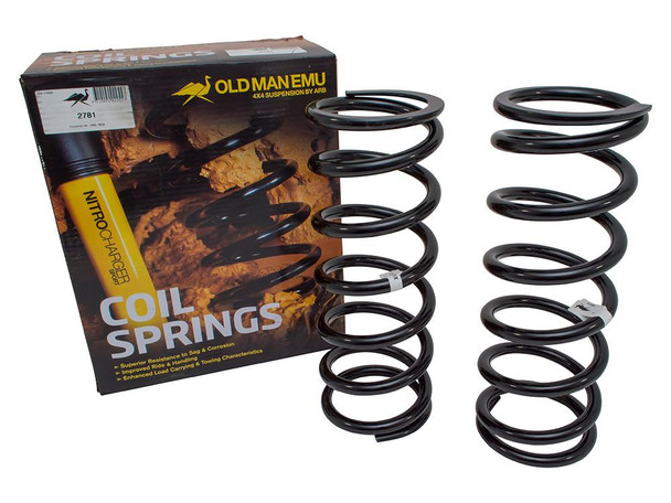 Old Man Emu OME Rear Coil Springs Plus 40mm Light Load for Discovery 2, set of two black coil springs with packaging in the background. Old Man Emu OME Rear Coil Springs Plus 40mm Light Load for Discovery 2, set of two black coil springs with packaging in the background.