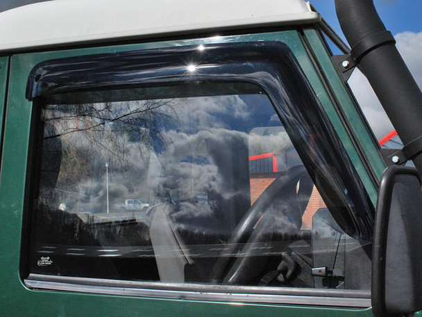 Britpart Front Window Wind Deflectors DA6078, installed on a vehicle's front window, designed to reduce noise and buffeting for Defender models.