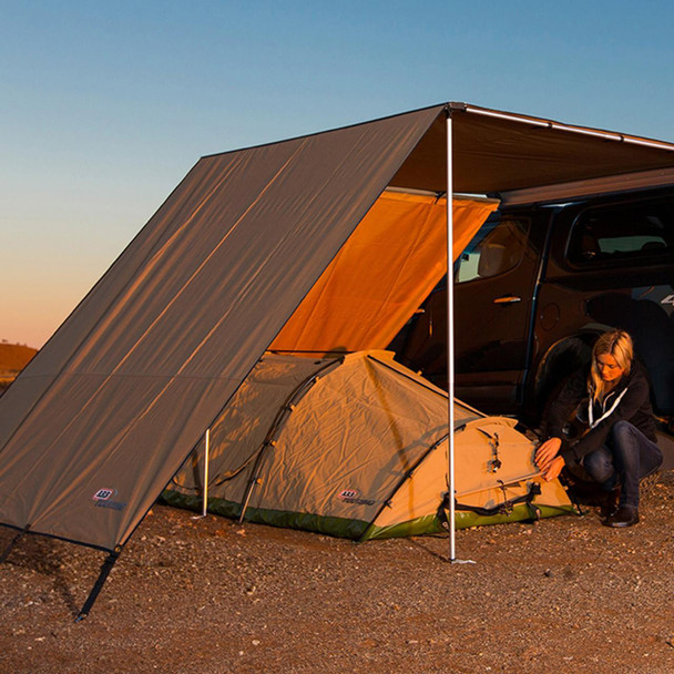 ARB 4X4 Accessories Expedition Awning Front Wind Break 2.5m ARB, outdoor setup with vehicle, camp tent, and wind break for camping and overlanding.