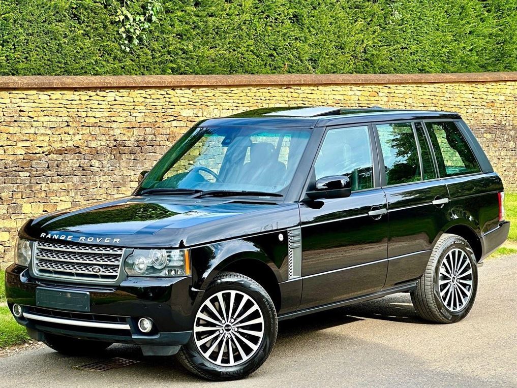 Range Rover L322 parked beside a stone wall