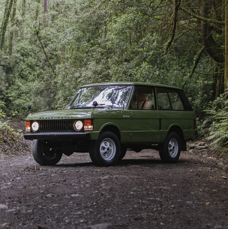 Range Rover Classic driving through a forest