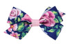 Navy floral printed butterfly bow with a flat light pink center, shown on a bitty clip