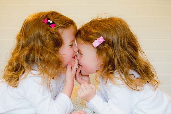 Cute fun hair clippies on twins smiling