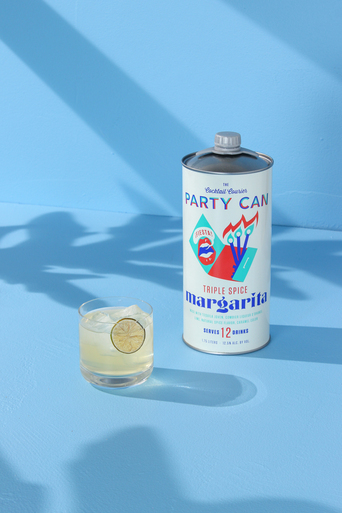 triple spice margarita can with drink poured on pastel background