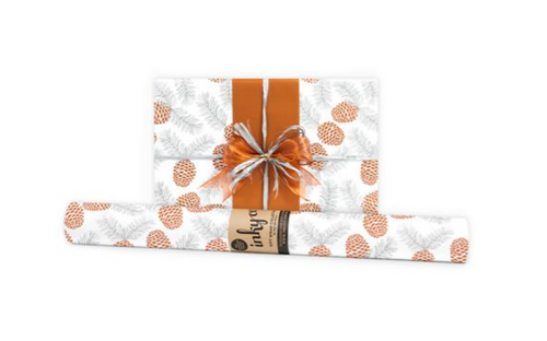 Pine Cones Copper Silver is a traditional Christmas design, featuring silver and copper inks on white wrapping paper.