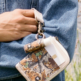 Thread Realtree Advantage Classic camo lip balm holder attached to wallet and clipped to jeans for easy access.