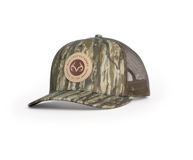 Angled view of Realtree Legacy camo trucker cap with round Realtree Outdoors patch main