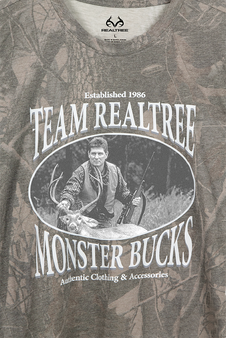 Close-up of the 40th Anniversary Team Realtree Monster Bucks graphic on a Realtree Hardwoods camo T-shirt.