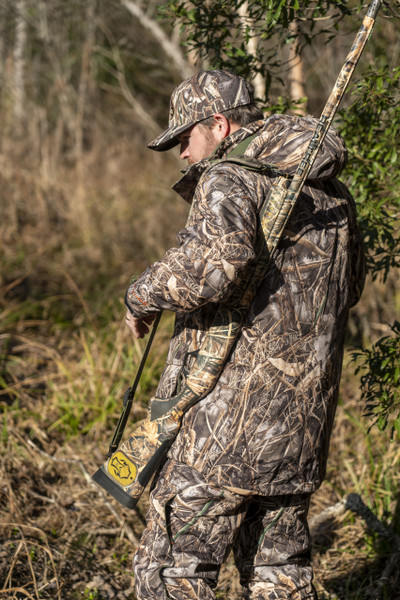 ArcticShield Tundra 3-in-1 Realtree MAX-7 camo bib worn in wetland terrain, featuring insulated bib design and articulated fit for cold-weather hunting.