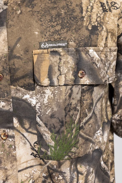 Close-up of Realtree logo and camo fabric on men’s APX long sleeve hunting shirt.